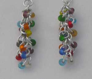 Anodized aluminum rings and glass beads colors: bright silver and multi-colored beads weave: shaggy loops size: 1  3/4