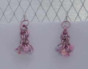 Anodized aluminum rings and beads colors: pink weave: rosette and shaggy loops size: 