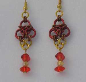Anodized aluminum rings and beads colors: red, bronze, and gold weave: aura size: 