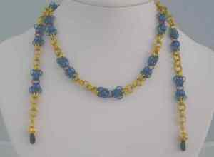 Anodized aluminum rings colors: royal blue, green, gold, and bronze weave: butterfly and 2 in 2 chain size: 27  3/4 includes clasp to allow use as necklace