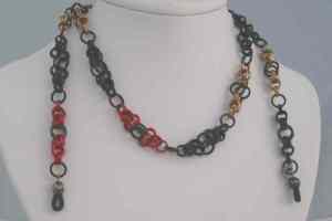 Anodized aluminum rings colors: red, black, and champagne weave: Asian bicycles size: 26  3/4 includes clasp to allow use as necklace