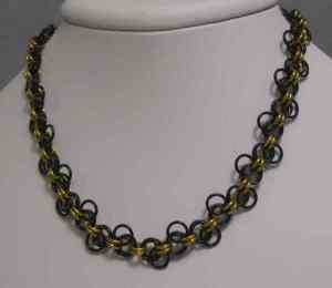 Anodized aluminum rings colors: black and gold weave: Lorenz's Forget-me-not size: 19